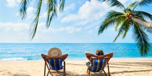 Couple relax on the beach enjoy beautiful sea on the tropical island. Summer beach vacation concept